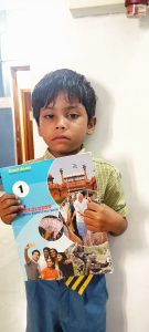 Ayan Class 1st Student Holding Book