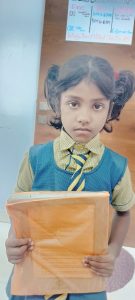 Mahek Class 1st Student Holding Book